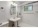 Classic bathroom with a pedestal sink, tiled shower, and neutral decor at 2816 S Wolff St, Denver, CO 80236