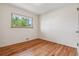 Cozy bedroom with hardwood floors, neutral walls, and a window offering natural light at 2816 S Wolff St, Denver, CO 80236
