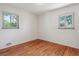Bright, hardwood-floored bedroom featuring dual windows and neutral wall color at 2816 S Wolff St, Denver, CO 80236