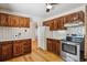 Traditional kitchen with wooden cabinets, white appliances, and ample counter space at 2816 S Wolff St, Denver, CO 80236