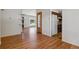 Open-concept living area with hardwood floors, neutral walls, and seamless flow to the kitchen at 2816 S Wolff St, Denver, CO 80236