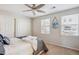 Cozy bedroom with ceiling fan, plush bedding, and ample natural light from two windows at 2362 Xanthia Way, Denver, CO 80238