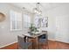 Dining room features a modern light fixture, hardwood floors, and neutral decor at 2362 Xanthia Way, Denver, CO 80238