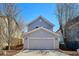 Two-story home featuring an attached two-car garage and mature trees at 2362 Xanthia Way, Denver, CO 80238