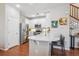 Well-lit kitchen features stainless steel appliances, white cabinets, and breakfast bar seating at 2362 Xanthia Way, Denver, CO 80238