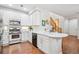 Bright kitchen with stainless steel appliances, quartz countertops, and ample cabinet space at 2362 Xanthia Way, Denver, CO 80238