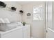 Functional laundry room featuring modern appliances and ample storage space at 2362 Xanthia Way, Denver, CO 80238