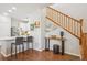 Bright living room showcasing an open layout with a staircase, kitchen bar, and contemporary design at 2362 Xanthia Way, Denver, CO 80238