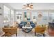 Inviting living room featuring large windows, hardwood floors, and a stylish seating arrangement at 2362 Xanthia Way, Denver, CO 80238