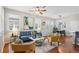 Stylish living room with hardwood floors, bright windows, and modern furniture arrangement at 2362 Xanthia Way, Denver, CO 80238