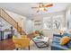 Bright living room with hardwood floors, ceiling fan, modern furniture, and large windows at 2362 Xanthia Way, Denver, CO 80238