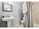 Modern bathroom with tiled shower-tub combo, vanity sink, and neutral color scheme at 915 26Th St, Denver, CO 80205
