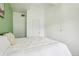 This bedroom is bright with white walls, a comfortable bed and a door to the side at 915 26Th St, Denver, CO 80205