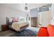 Bright bedroom featuring a comfortable bed, red sofa, and modern lighting at 915 26Th St, Denver, CO 80205