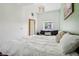 Bedroom featuring a comfortable bed, dark sofa, and large window at 915 26Th St, Denver, CO 80205