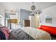 Cozy bedroom featuring a comfortable bed, red sofa, and a mini kitchen with modern appliances at 915 26Th St, Denver, CO 80205