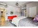 Bright bedroom featuring a comfortable bed, red sofa, and modern lighting at 915 26Th St, Denver, CO 80205