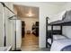 This shared bedroom features dark bunkbeds and light laminate flooring at 915 26Th St, Denver, CO 80205
