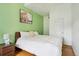 This bedroom has a calming feel, with its green wall and wood-look floors at 915 26Th St, Denver, CO 80205