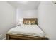 Inviting bedroom featuring a wood bed frame, patterned accent pillows and natural light at 915 26Th St, Denver, CO 80205