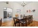 Open dining area with a long table, chandelier, and access to the kitchen at 915 26Th St, Denver, CO 80205