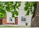 Charming exterior of home with a red door, complemented by green foliage for added curb appeal at 915 26Th St, Denver, CO 80205