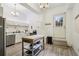 Bright kitchen featuring stainless steel appliances, ample storage, a kitchen island, and modern lighting fixtures at 915 26Th St, Denver, CO 80205