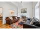 Bright living room featuring hardwood floors, two sofas, and a colorful area rug at 915 26Th St, Denver, CO 80205