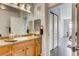 Bright bathroom with wooden cabinets and drawers, and a sliding door to the Primary bedroom at 13456 Via Varra # 315, Broomfield, CO 80020