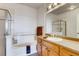 Bright bathroom featuring a bathtub, shower with a glass door, and ample cabinet space at 13456 Via Varra # 315, Broomfield, CO 80020