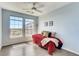 Bedroom with bright natural light from the two windows, with gray hardwood flooring at 13456 Via Varra # 315, Broomfield, CO 80020