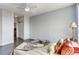 Bedroom featuring hardwood floors, light blue walls, and a plush bed with decorative pillows at 13456 Via Varra # 315, Broomfield, CO 80020
