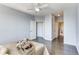 Bedroom with light blue walls, hardwood floors, and views to an ensuite bath and walk-in closet at 13456 Via Varra # 315, Broomfield, CO 80020