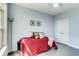 Bedroom featuring a comfortable bed, hardwood floors, and natural light from the adjacent window at 13456 Via Varra # 315, Broomfield, CO 80020