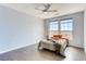 Cozy bedroom with light blue walls, hardwood floors, and two bright windows providing natural light at 13456 Via Varra # 315, Broomfield, CO 80020