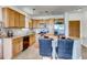 Bright kitchen featuring light wood cabinetry, stainless steel appliances, and a cozy breakfast bar with seating at 13456 Via Varra # 315, Broomfield, CO 80020