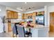 Bright kitchen featuring light wood cabinetry, stainless steel appliances, and a cozy breakfast bar with seating at 13456 Via Varra # 315, Broomfield, CO 80020