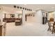 Spacious finished basement with plush carpeting, ample seating, and a cozy atmosphere for relaxation and entertainment at 8385 Briar Trace Dr, Castle Pines, CO 80108