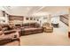 Finished basement featuring a large seating area, kitchenette, and stairs leading to the upper level at 8385 Briar Trace Dr, Castle Pines, CO 80108