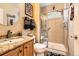 Bathroom featuring vanity with granite countertop, framed mirror, tiled shower, toilet and artistic decor at 8385 Briar Trace Dr, Castle Pines, CO 80108