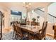 Open dining room with hardwood floors, seating for eight, and an adjacent living room at 8385 Briar Trace Dr, Castle Pines, CO 80108