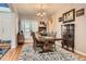 Dining room with hardwood floors, a large wooden table, and natural light at 8385 Briar Trace Dr, Castle Pines, CO 80108