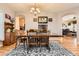 Spacious dining room featuring hardwood floors, seating for six, and an adjacent kitchen at 8385 Briar Trace Dr, Castle Pines, CO 80108