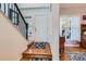 Entryway with a hardwood floor leading to staircase and other rooms at 8385 Briar Trace Dr, Castle Pines, CO 80108