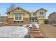 Inviting home exterior featuring stone accents, well-maintained landscaping, and a two-car garage at 8385 Briar Trace Dr, Castle Pines, CO 80108