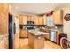Bright kitchen featuring wood cabinets, stainless steel appliances, granite countertops, and center island at 8385 Briar Trace Dr, Castle Pines, CO 80108