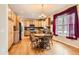 Eat-in kitchen featuring wood cabinets, stainless appliances, and adjacent dining area with natural light at 8385 Briar Trace Dr, Castle Pines, CO 80108