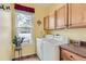 Functional laundry room with cabinets and a window offering natural light at 8385 Briar Trace Dr, Castle Pines, CO 80108