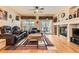 Inviting living room featuring hardwood floors, fireplace, comfortable seating, and abundant natural light at 8385 Briar Trace Dr, Castle Pines, CO 80108