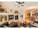 Open concept living room with fireplace, hardwood floors, and modern furnishings at 8385 Briar Trace Dr, Castle Pines, CO 80108